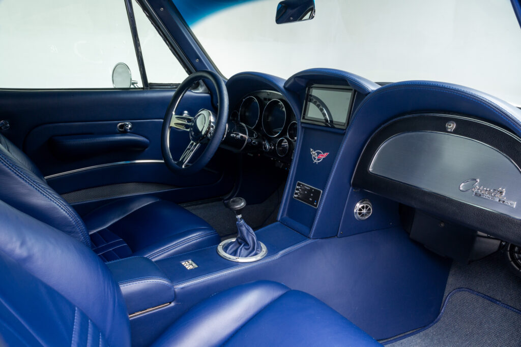 Custom blue leather interior showing the dashboard and gear shift in a 1963 Split-Window Corvette custom coupe restomod built by Verrillo Motor Car Co.