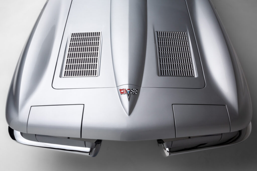 Closeup of the hood of a 1963 Split-Window Corvette custom coupe restomod in Silver Pearl built by Verrillo Motor Car Co.